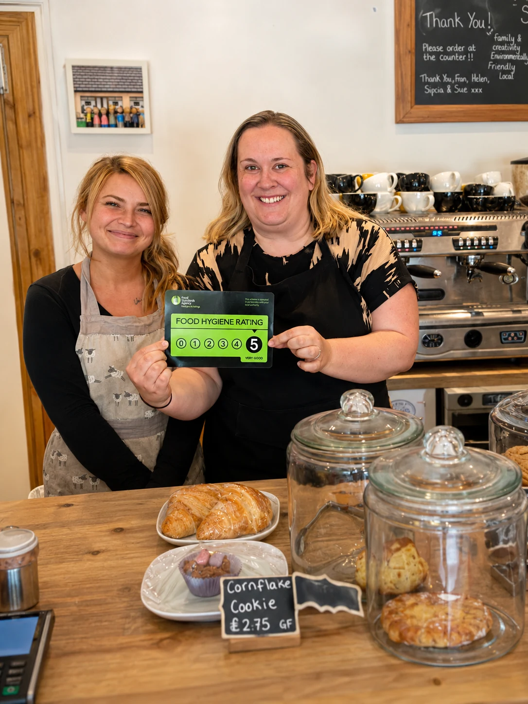 Two members of the Betty Bee's team holding a five-star food hygiene rating